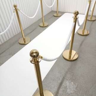 White carpet with white ropes and gold stanchions