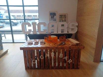 Cigar bar table rental with the cigars Marquee letters and table rental